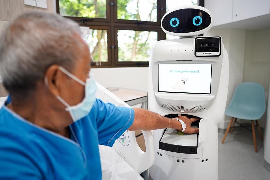  ​Florence is an automated robot which is able to carry out certain tasks such as measuring a patient's respiratory rate and vital signs. ST PHOTO SYAMIL SAPARI